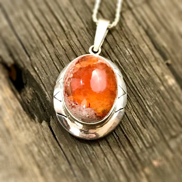 a red/orange en cantera Mexican opal in a traditional sterling sliver setting